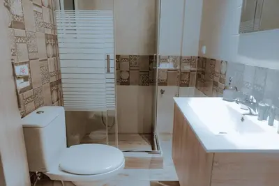 a bathroom with a toilet and a sink and a shower at Acropolis Museum Stylish Apartments in Athens