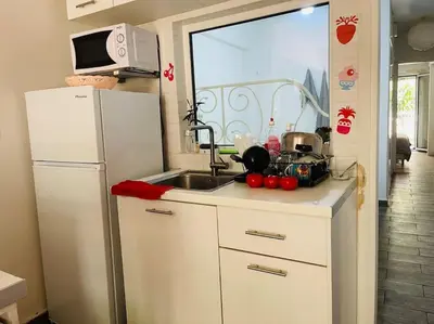 a kitchen with a sink and a refrigerator at A comfortable apartment to you in Athens