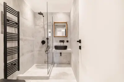a bathroom with a glass shower and a sink at Nana's Residence in Athens