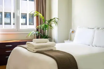 a bedroom with a bed with towels and a plant at Acropolis, Falirou in Athens