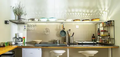 a kitchen with a counter with stools in it at Acropolis, Falirou in Athens