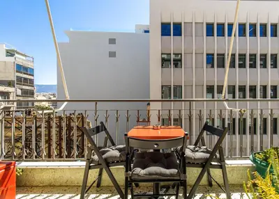 a table and two chairs on a balcony at Acropolis, Falirou in Athens