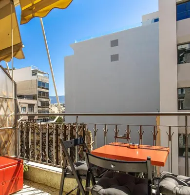 a orange table and chairs on a balcony at Acropolis, Falirou in Athens