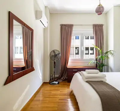 a bedroom with a bed and a mirror at Acropolis, Falirou in Athens