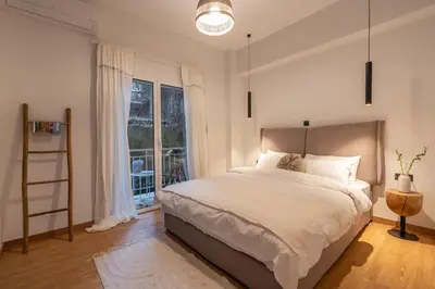 a bedroom with a large bed and a window at The Heart Of Athens in Athens