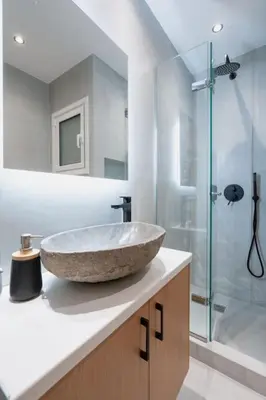 a bathroom with a stone sink and a shower at The Heart Of Athens in Athens