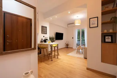 a kitchen and living room with a table and chairs at The Heart Of Athens in Athens