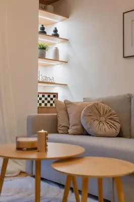 a living room with a couch and two tables at The Heart Of Athens in Athens