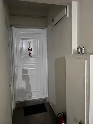 a white door with a cross on it in a room at Top floor apartment in Athens