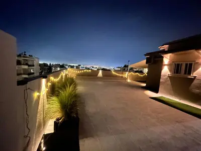 a balcony with lights on the side of a building at Top floor apartment in Athens