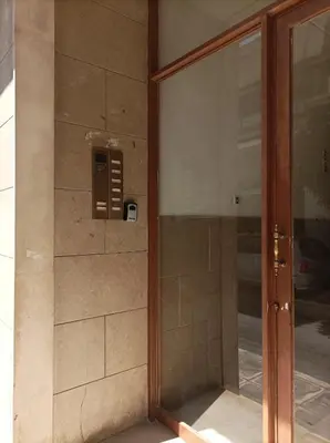 a glass door of a building with a phone at Calypso in Athens