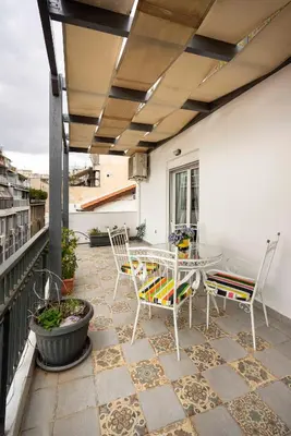 a patio with chairs and a table on a balcony at Mirabella spacious studio in Athens