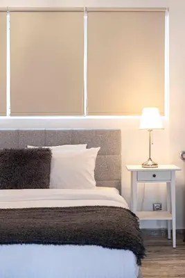 a bedroom with a bed and a table with a lamp at Mirabella spacious studio in Athens