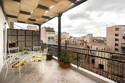 a balcony with tables and chairs and a view of a city at Mirabella spacious studio in Athens