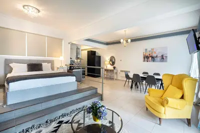 a bedroom with a bed and a living room at Mirabella spacious studio in Athens