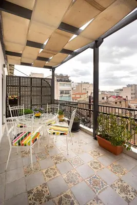 a patio with tables and chairs on a balcony at Mirabella spacious studio in Athens