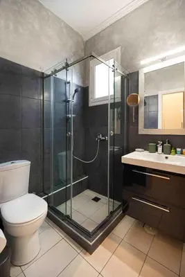 a bathroom with a shower and a toilet and a sink at Mirabella spacious studio in Athens
