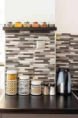 a kitchen counter with jars of food on a shelf at Mirabella spacious studio in Athens