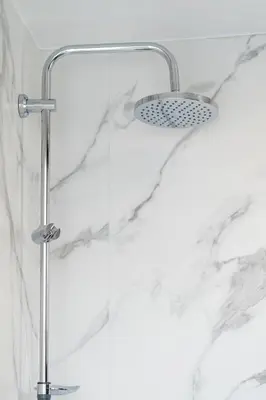 a shower with a shower head in a bathroom at Olvar Suites in Athens