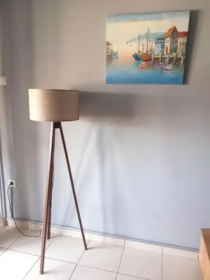 a lamp in a room with a painting on the wall at Staying besides Acropolis! in Athens