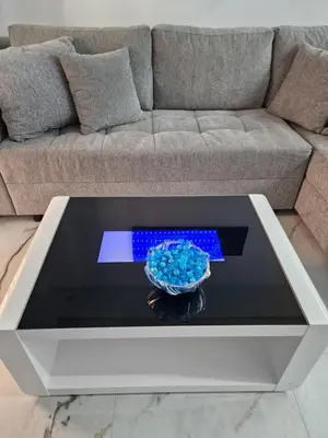 a coffee table in a living room with a couch at Luxury apartment in Attiki in Athens