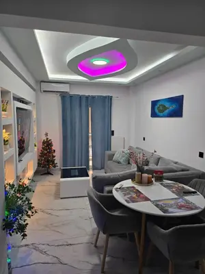 a living room with a purple light on the ceiling at Luxury apartment in Attiki in Athens