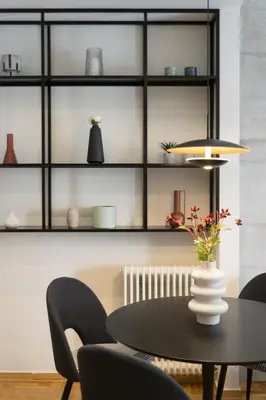 a dining room with a black table and chairs at Callirhoē Luxury 2BD Acropolis Apartment in Athens