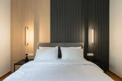 a bedroom with a large bed with white pillows at Callirhoē Luxury 2BD Acropolis Apartment in Athens