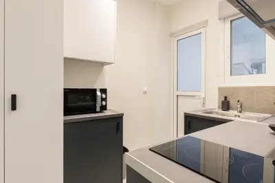 a kitchen with a microwave and a sink at Callirhoē Luxury 2BD Acropolis Apartment in Athens