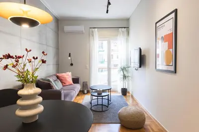 a living room with a couch and a table at Callirhoē Luxury 2BD Acropolis Apartment in Athens