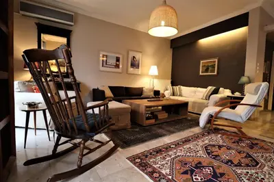 a living room with a chair and a couch at Amazing penthouse in Ambelokipi in Athens