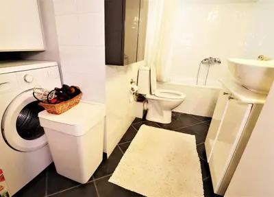 a white bathroom with a toilet and a sink at Amazing penthouse in Ambelokipi in Athens