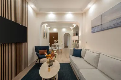 a living room with a couch and a table at LIV - Vintage Acropolis Apartment in Athens