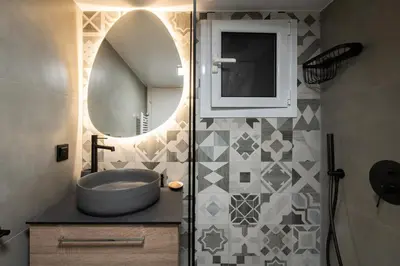 a bathroom with a sink and a mirror at LIV - Vintage Acropolis Apartment in Athens