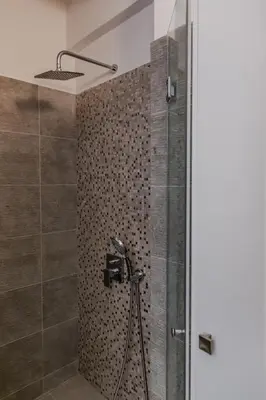 a shower with a glass door in a bathroom at SYNTAGMA VOULIS STREET MODERN APARTMENT in Athens