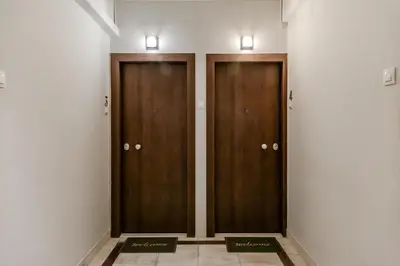 two wooden elevators in a room with white walls at SYNTAGMA VOULIS STREET MODERN APARTMENT in Athens
