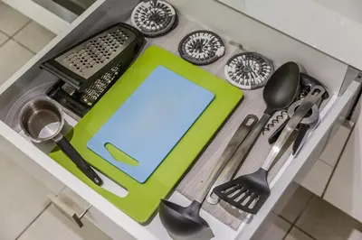 a drawer filled with kitchen utensils and a clipboard at SYNTAGMA VOULIS STREET MODERN APARTMENT in Athens