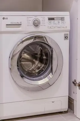 a white washing machine sitting in a room at SYNTAGMA VOULIS STREET MODERN APARTMENT in Athens