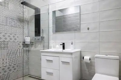 a white bathroom with a toilet and a sink at Comfort & Relax apartment in Athens Riviera in Athens