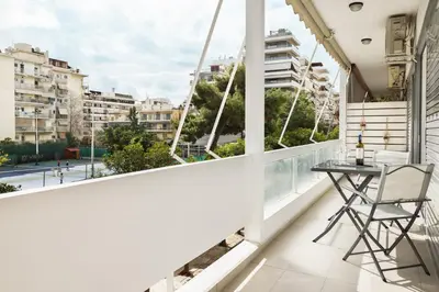 a balcony with a table and a view of a city at Comfort & Relax apartment in Athens Riviera in Athens