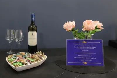 a table with a bottle of wine and a plate of food at Comfort & Relax apartment in Athens Riviera in Athens