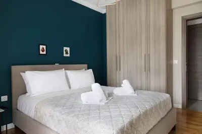 a bedroom with a bed with two white towels on it at Comfort & Relax apartment in Athens Riviera in Athens