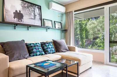 a living room with a couch and a table at Glyfada 2 bedrooms 4 persons apartment by MPS in Athens