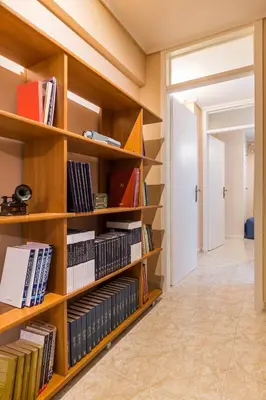 a library with wooden shelves filled with books at Glyfada 2 bedrooms 4 persons apartment by MPS in Athens