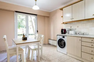 a kitchen with a table and a washing machine at Glyfada 2 bedrooms 4 persons apartment by MPS in Athens