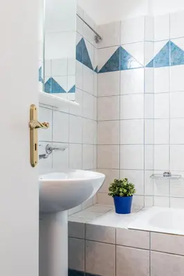 a white bathroom with a sink and a tub at Glyfada 2 bedrooms 4 persons apartment by MPS in Athens