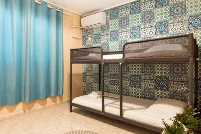 a bedroom with two bunk beds and a blue wall at Glyfada 2 bedrooms 4 persons apartment by MPS in Athens