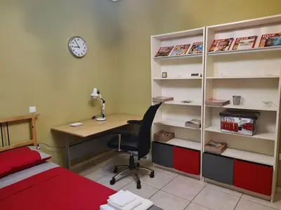 a room with a desk and a bed and a desk and a desk at Άνετο, μεγάλο σπίτι κοντά στο μετρό in Piraeus