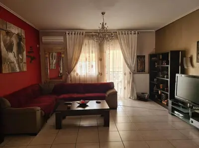 a living room with a couch and a coffee table at Άνετο, μεγάλο σπίτι κοντά στο μετρό in Piraeus