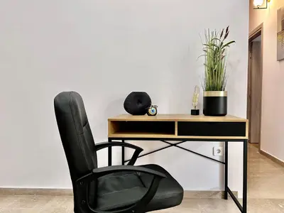 a black chair in front of a desk with a chair at Elaia Luxury Selections Sapphire in Athens